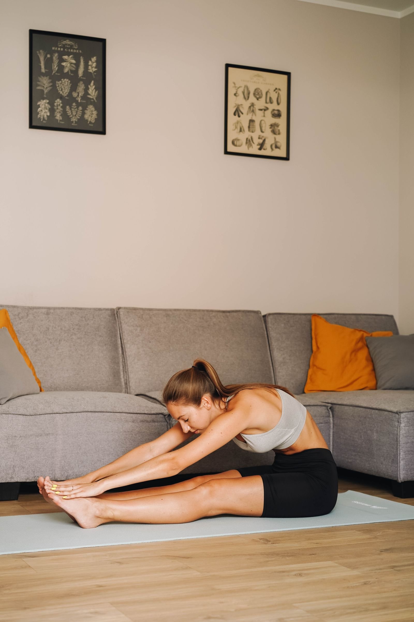 Donna fa stretching ed esercizi drenanti a casa sul tappetino