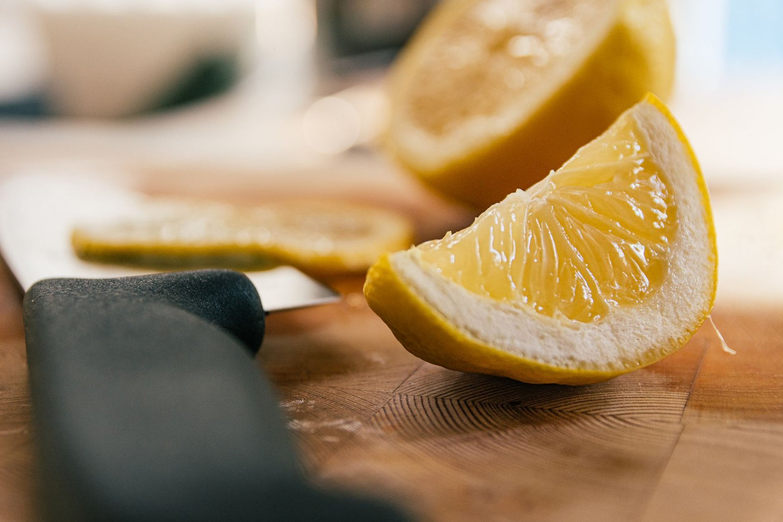 Fette di limone appena tagliate su un tagliere di legno